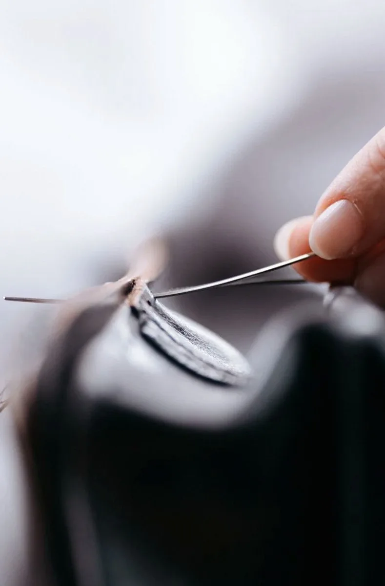 Hand stitching an underwire casing with needle and thread