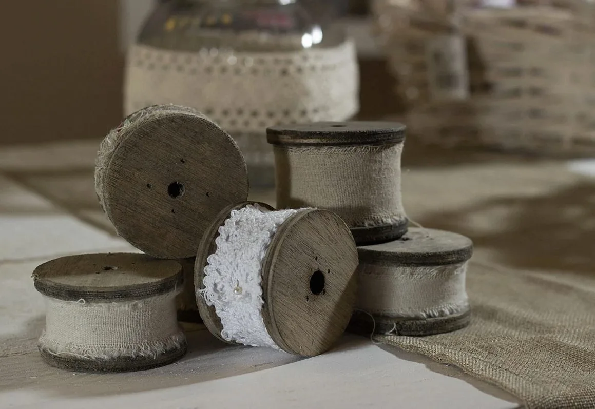 Reels of lace trim on a workbench